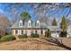 Charming brick home featuring dormer windows, a well-manicured lawn, and a two-car garage at 5352 Waterford Dr, Dunwoody, GA 30338