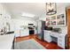 Spacious kitchen featuring white cabinetry, stainless steel appliances, and hardwood floors at 5352 Waterford Dr, Dunwoody, GA 30338