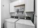 Laundry room featuring white washer and dryer and white cabinets above at 5352 Waterford Dr, Dunwoody, GA 30338