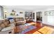 Cozy living room with hardwood floors, a comfortable sectional sofa, and curated shelving at 5352 Waterford Dr, Dunwoody, GA 30338