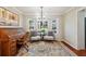 Cozy sitting room featuring a vintage roll-top desk, hardwood floors, and bay windows at 5352 Waterford Dr, Dunwoody, GA 30338