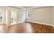 This bedroom features neutral walls, wood floors, and a door to an ensuite bathroom at 645 Trailmore Pl, Roswell, GA 30076