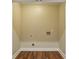 Large walk-in closet featuring wood floors, neutral walls, and plumbing hook-ups at 645 Trailmore Pl, Roswell, GA 30076