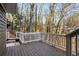 A deck with stairs leading to the backyard that overlooks a wooded area at 645 Trailmore Pl, Roswell, GA 30076