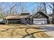 Charming single-story home featuring a two-car garage, stone accents and manicured front lawn at 645 Trailmore Pl, Roswell, GA 30076