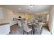 Open-concept dining area with a modern table and chairs, flowing into the kitchen and living space at 7706 Sudbury Cir, Covington, GA 30014