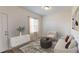 Cozy living room with a neutral color palette, stylish furniture, and natural light from the window at 7706 Sudbury Cir, Covington, GA 30014