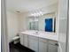 Bright bathroom featuring a large mirror, white cabinets, and a walk-in shower at 7722 Sudbury Cir, Covington, GA 30014