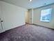 Carpeted bedroom featuring a window and a door at 7722 Sudbury Cir, Covington, GA 30014