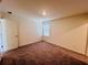 A comfortable carpeted bedroom featuring a window and a door at 7722 Sudbury Cir, Covington, GA 30014