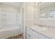 Bathroom featuring a sink, white vanity, and bathtub with tile surround at 401 Cabriolet Ct, Mcdonough, GA 30253