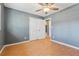 Bedroom with wood floors has a ceiling fan, a window, and closet space at 401 Cabriolet Ct, Mcdonough, GA 30253