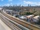 Scenic aerial view of a neighborhood with modern buildings and train tracks, with the city skyline in the background at 964 Dekalb Ne Ave # 112, Atlanta, GA 30307