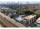 An attractive aerial view of a building with a dark rooftop, parking and the city skyline in the distance at 964 Dekalb Ne Ave # 112, Atlanta, GA 30307