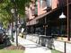 Outdoor dining area with a covered patio and a brick building in the background at 964 Dekalb Ne Ave # 112, Atlanta, GA 30307