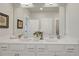 Bathroom featuring white cabinetry, double sinks, a large mirror, and modern fixtures at 2030 Main Nw St # 205, Atlanta, GA 30318