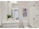 Well-lit bathroom with a shower-tub combo, a large mirror and a decorative plant at 2030 Main Nw St # 205, Atlanta, GA 30318