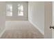 Spacious bedroom features two large windows, neutral tones, and carpeted flooring at 2030 Main Nw St # 205, Atlanta, GA 30318