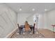 Dining area with a black table, seating for four, modern rug, and decorative wall paneling at 2030 Main Nw St # 205, Atlanta, GA 30318