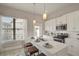 Modern kitchen with white cabinets, stainless steel appliances, a bright window, and an island with seating at 2030 Main Nw St # 205, Atlanta, GA 30318