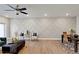 Open living area showcasing ceiling fan, decorative accent wall, and modern furniture at 2030 Main Nw St # 205, Atlanta, GA 30318