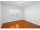 Cozy bedroom featuring hardwood floors, wainscoting, and a large window for natural light at 510 Debra Dr, Marietta, GA 30066