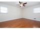 Bedroom features hardwood floors, modern ceiling fan, and lots of natural light from two windows at 510 Debra Dr, Marietta, GA 30066