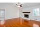 Spacious living room featuring a brick fireplace, hardwood floors, and a ceiling fan at 510 Debra Dr, Marietta, GA 30066