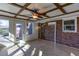 Inviting sunroom with a ceiling fan, brick accent wall, and lots of windows at 510 Debra Dr, Marietta, GA 30066