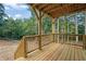 Wooden deck with railing overlooking green lush forest at 553 Somersby Dr, Dallas, GA 30157