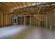 Unfinished basement ready for customization, featuring exposed beams, duct work, and concrete floors at 553 Somersby Dr, Dallas, GA 30157