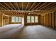 Unfinished basement with wooden beams and natural light through windows at 553 Somersby Dr, Dallas, GA 30157