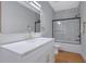 Bathroom featuring a double vanity with quartz countertop, a large mirror, and a glass-enclosed shower at 553 Somersby Dr, Dallas, GA 30157