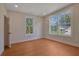 Bright bedroom features hardwood floors, two large windows and neutral paint at 553 Somersby Dr, Dallas, GA 30157