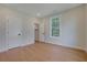 Light-filled bedroom with wood floors and access to closet and ensuite bathroom at 553 Somersby Dr, Dallas, GA 30157