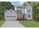 Charming new two-story home with white siding, inviting porch, attached garage, and manicured front yard at 553 Somersby Dr, Dallas, GA 30157