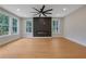 Open-concept living room with hardwood floors, modern fireplace, and large windows, providing abundant natural light at 553 Somersby Dr, Dallas, GA 30157