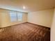 A spacious bedroom with carpet, two windows and neutral paint at 7714 Sudbury Cir, Covington, GA 30014