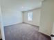 Large bedroom with carpeted floors and a sunny window at 7714 Sudbury Cir, Covington, GA 30014