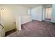 A carpeted upper landing with a view of the staircase and hallway at 7714 Sudbury Cir, Covington, GA 30014