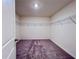 Spacious walk-in closet features carpeted flooring and wire shelving throughout at 7714 Sudbury Cir, Covington, GA 30014