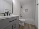 Modern bathroom with white marble shower and a dark vanity and black hardware at 8168 Spring Ct, Riverdale, GA 30274