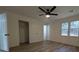 A spacious bedroom with modern ceiling fan and wood-look floors at 8168 Spring Ct, Riverdale, GA 30274