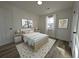 Bright, airy bedroom features a bed, bedside tables, and complementary art pieces at 8168 Spring Ct, Riverdale, GA 30274