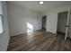 This bedroom features wood-look flooring, neutral walls, and a closet at 8168 Spring Ct, Riverdale, GA 30274