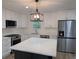 Updated kitchen with stainless appliances, island and modern pendant lighting at 8168 Spring Ct, Riverdale, GA 30274