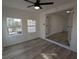 Sunroom has bright natural light with ceiling fan and adjacent access to main room at 8168 Spring Ct, Riverdale, GA 30274