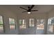 Natural light fills this sunroom with a ceiling fan and direct access to the outside at 8168 Spring Ct, Riverdale, GA 30274