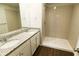 Bathroom featuring a double sink vanity, granite countertops, and a tiled shower at 8656 Webb Rd, Riverdale, GA 30274