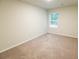 Cozy bedroom with neutral carpet and a window with views of the neighborhood at 8656 Webb Rd, Riverdale, GA 30274